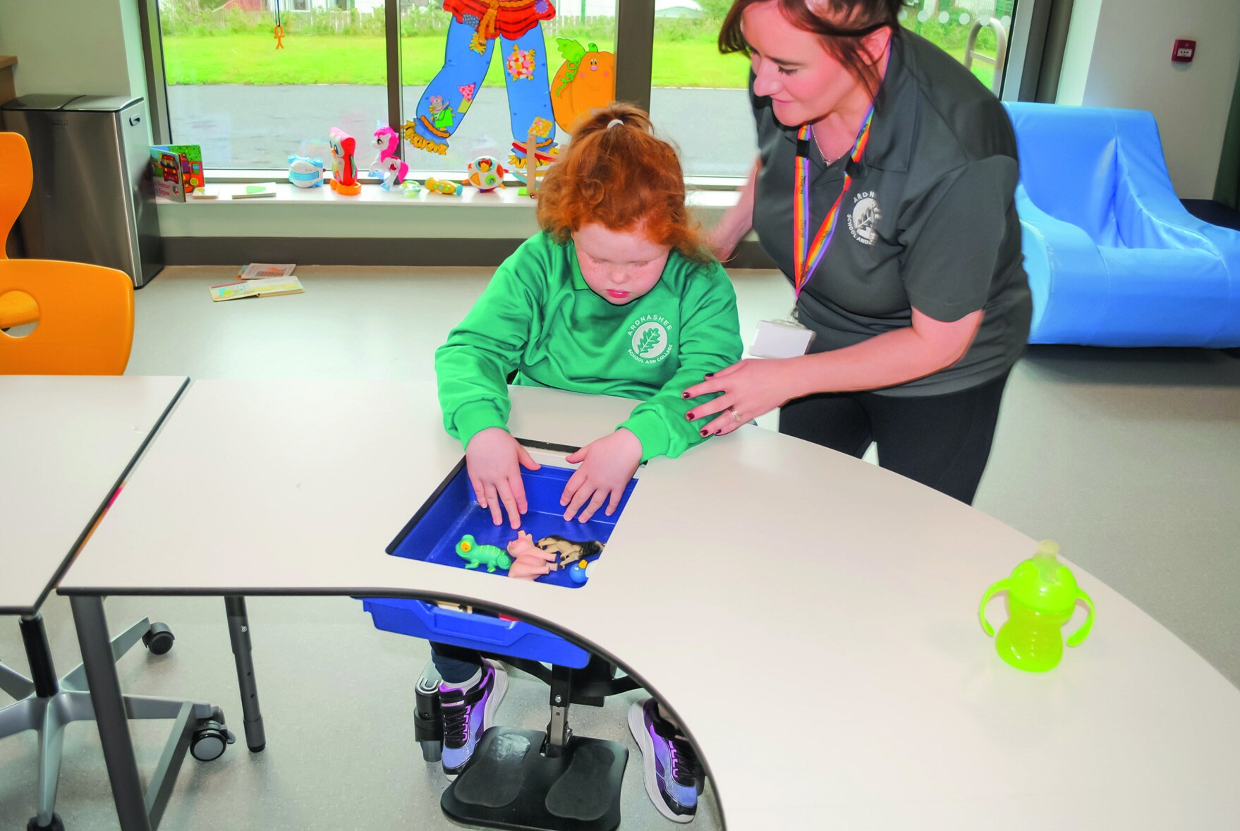 A pupil and member of staff using a curved VS table at Ardnashee SEN School and College