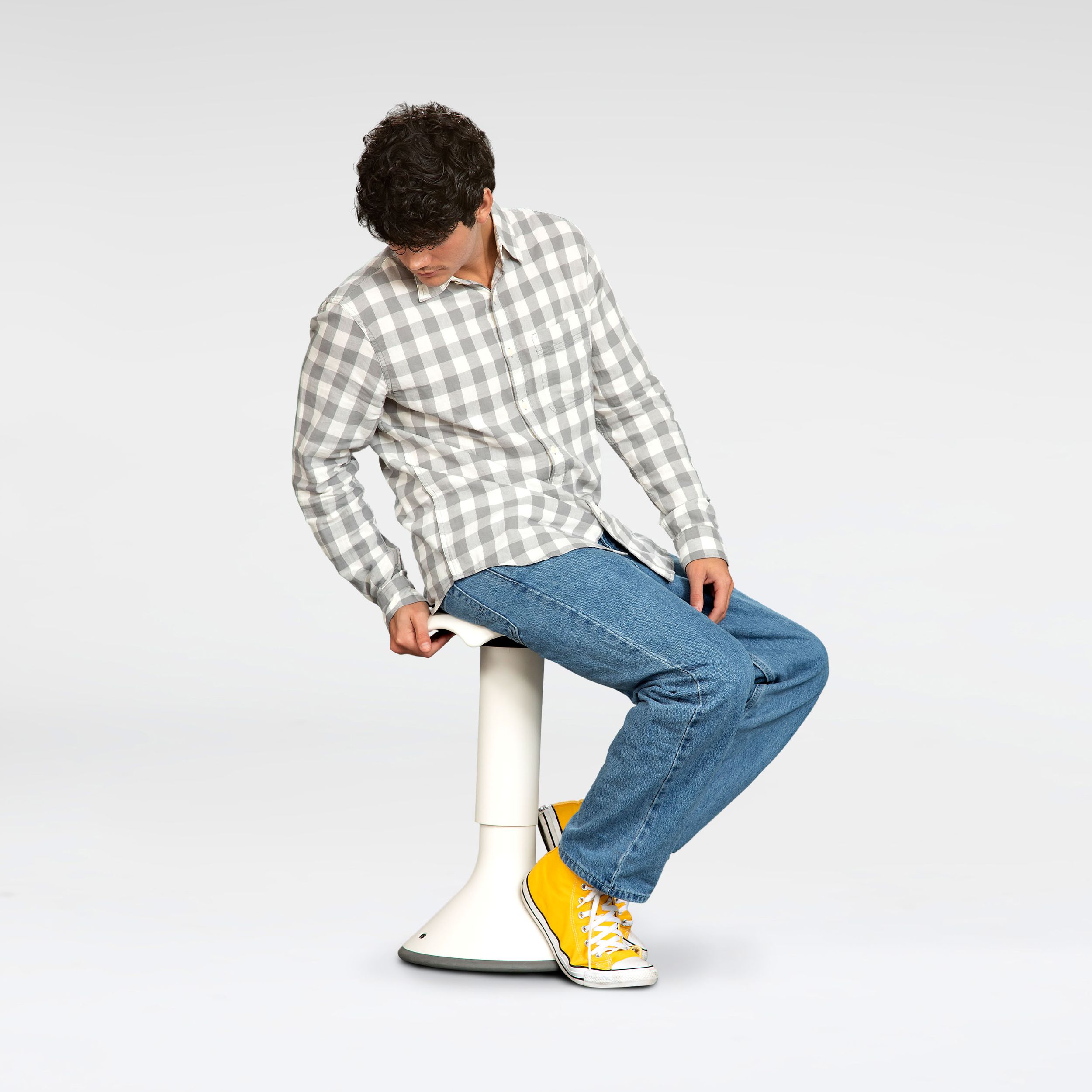 Person sitting dynamically on a white VS Hokki active stool